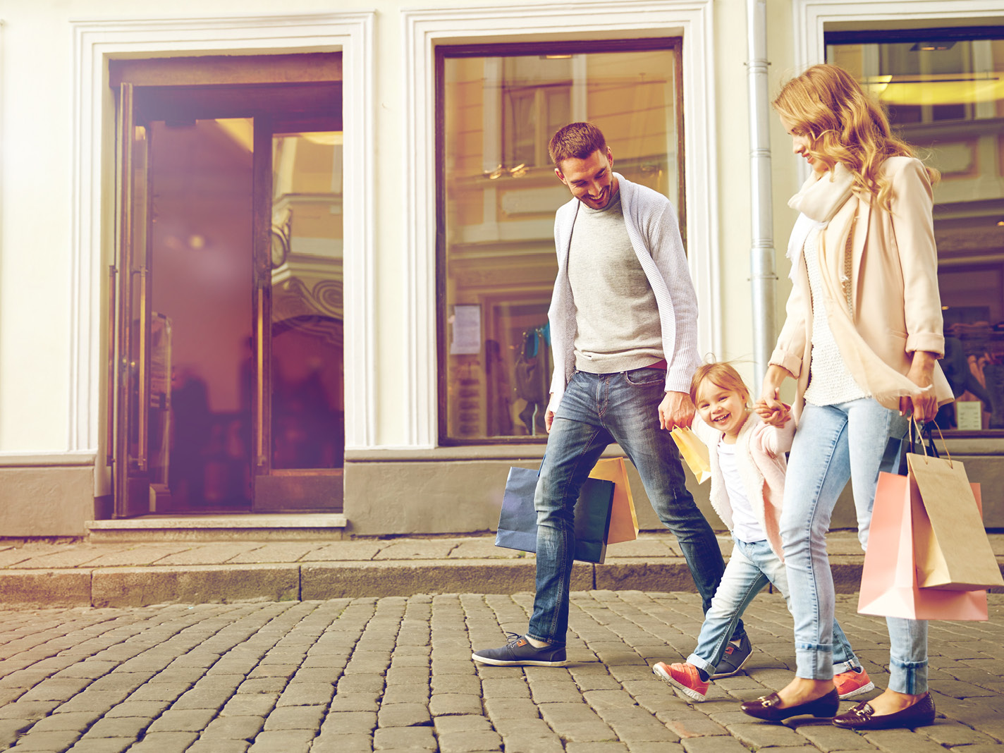 A family outside shops valued by CBRE property valuers