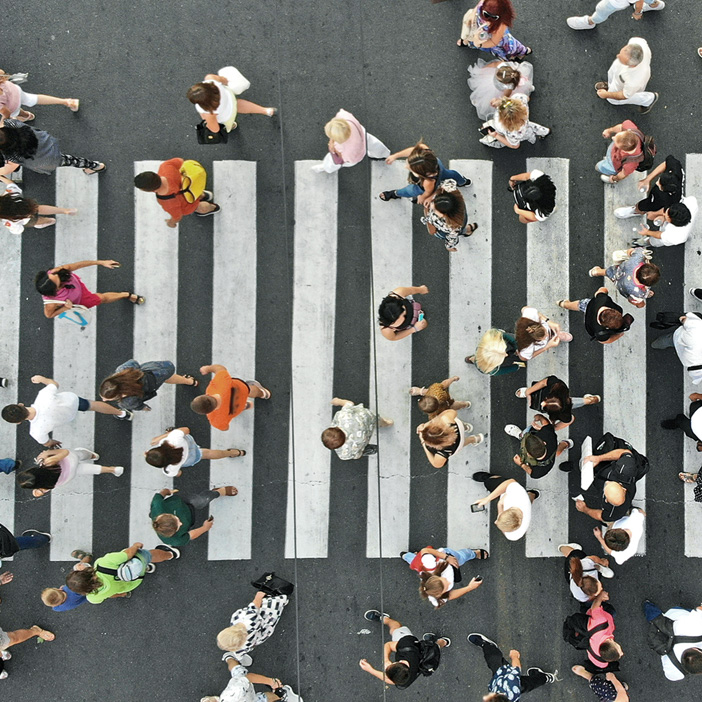 Overheard view of busy crosswalk with many people walking