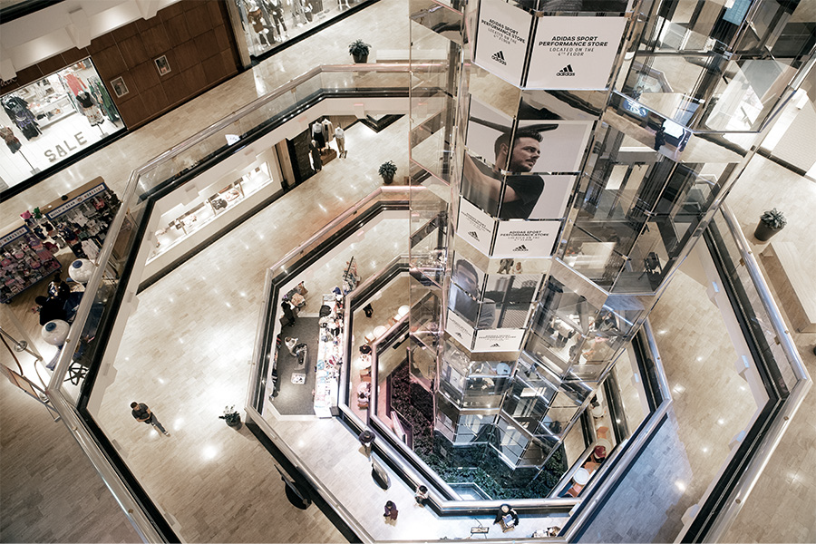 Interior of a shopping mall with multiple floors and escalators.