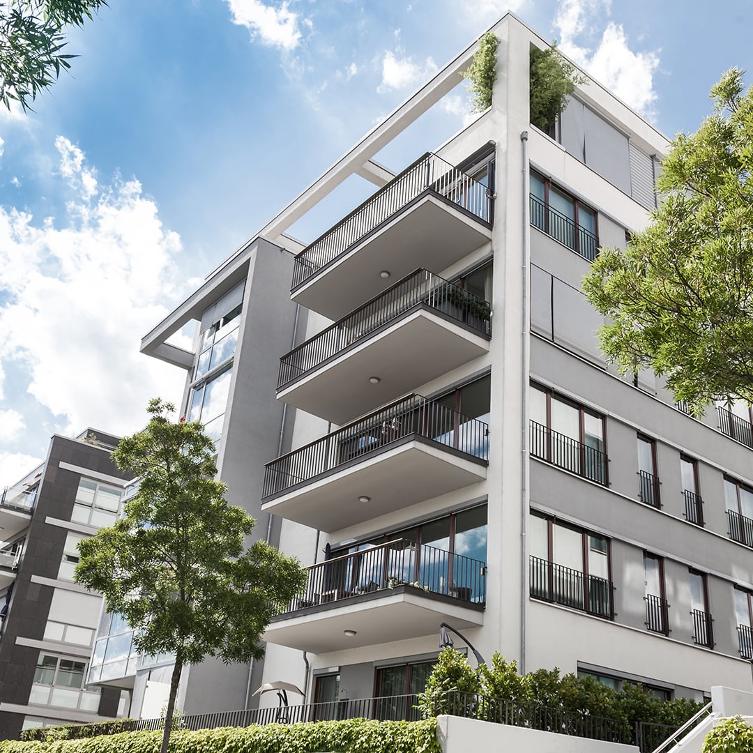 Modern multi‑story apartment building with balconies and contemporary architectural design