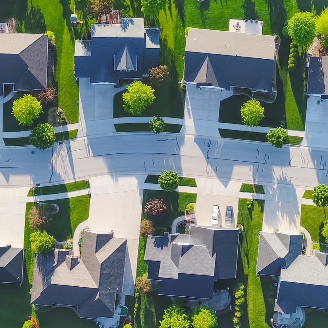 Aerial view of diverse residential neighborhood showcasing mixed housing portfolio for optimized real estate performance