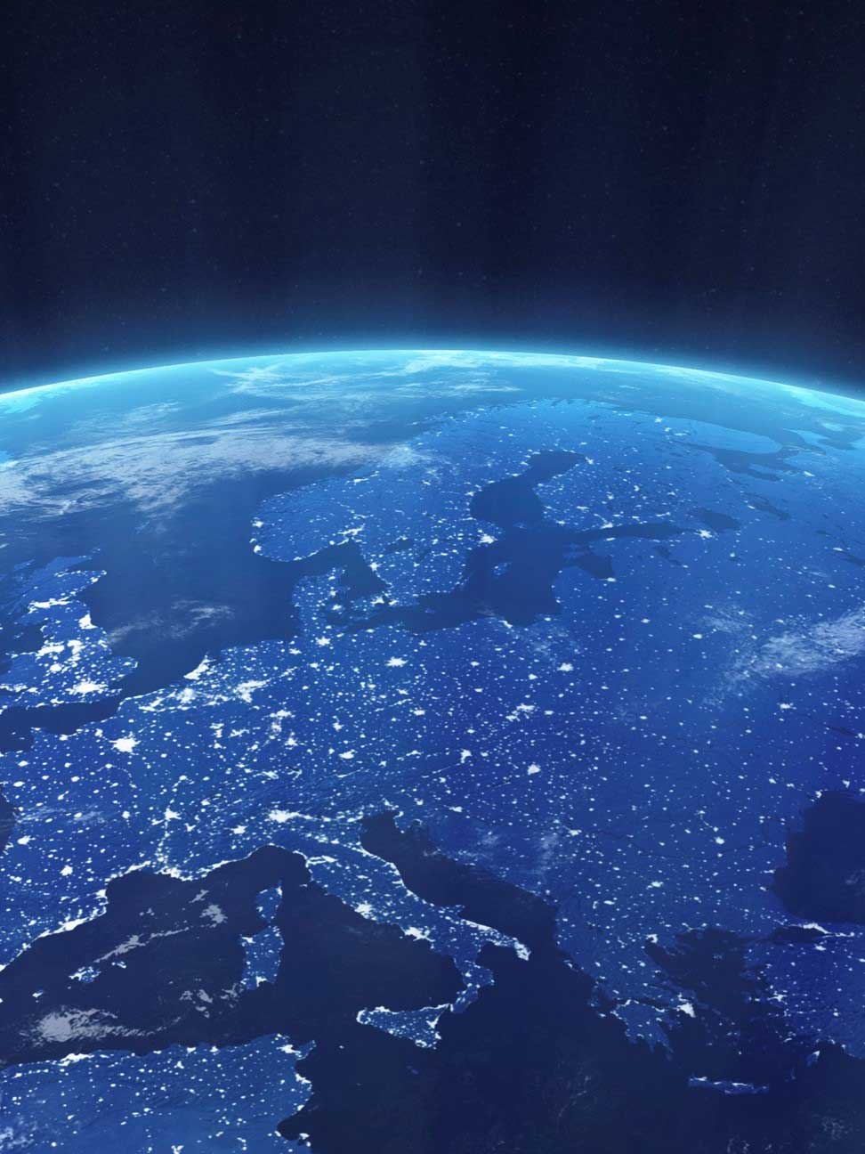 Satellite view of Earth at night showing Europe illuminated by city lights against a dark space background