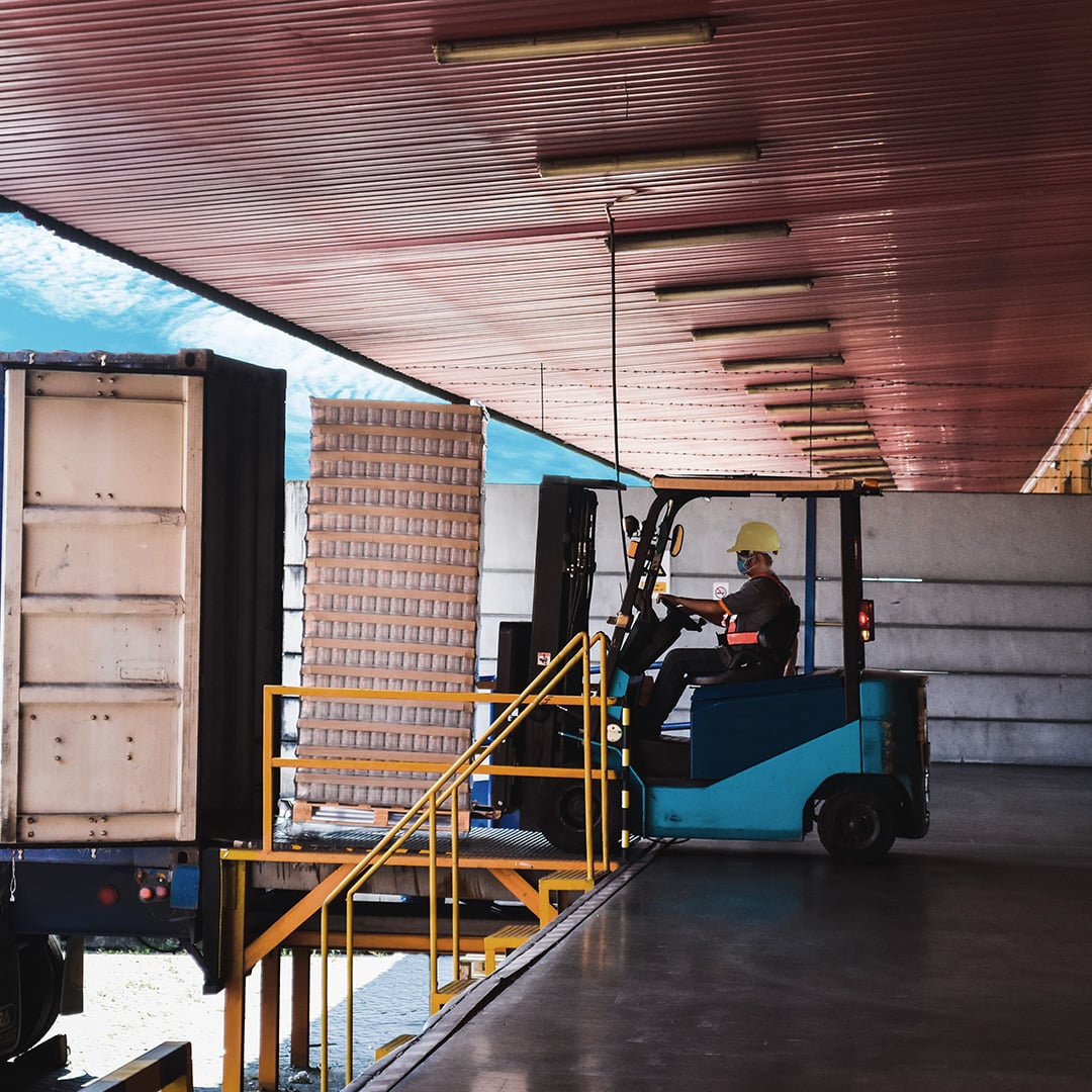 Person unloading a truck with a forklift