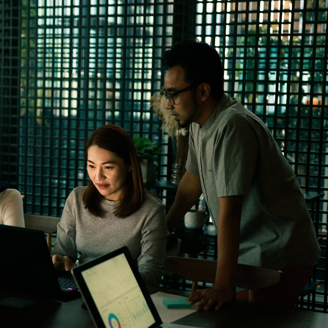 Two people looking at a computer