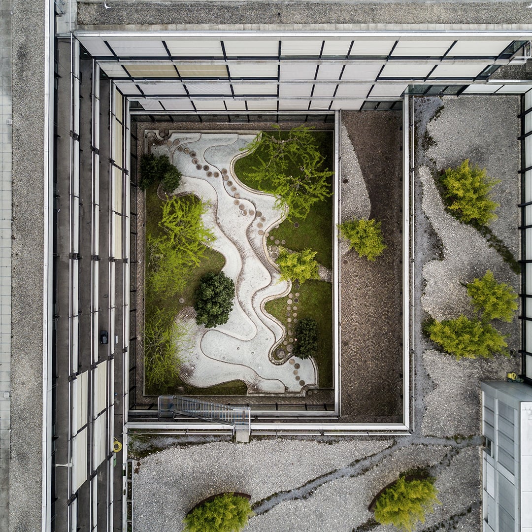 A courtyard with a garden and trees