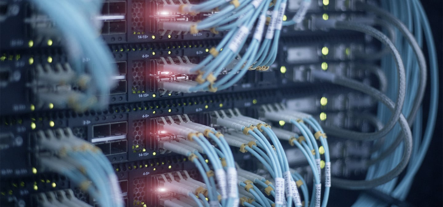 Close-up of network cables connected to server racks inside a data center