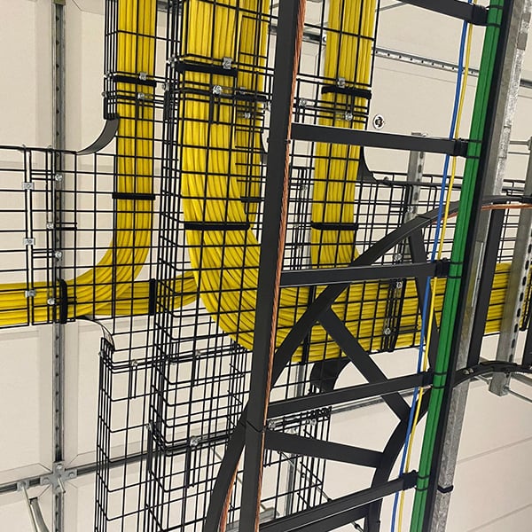 Organized network cabling installed in metal trays inside a high-capacity data center supporting large-scale commercial infrastructure.