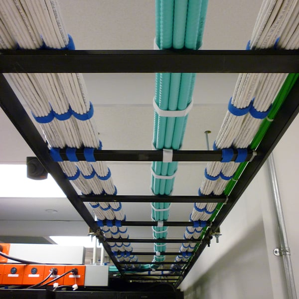 Organized network cabling installed in metal trays inside a high-capacity data center supporting large-scale commercial infrastructure.