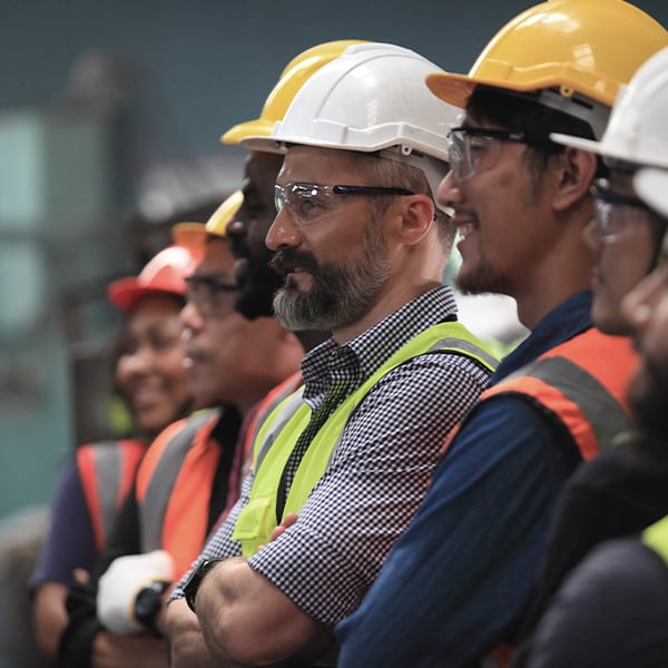 Infrastructure professionals wearing safety gear on-site at a data center supporting mission-critical commercial operations.
