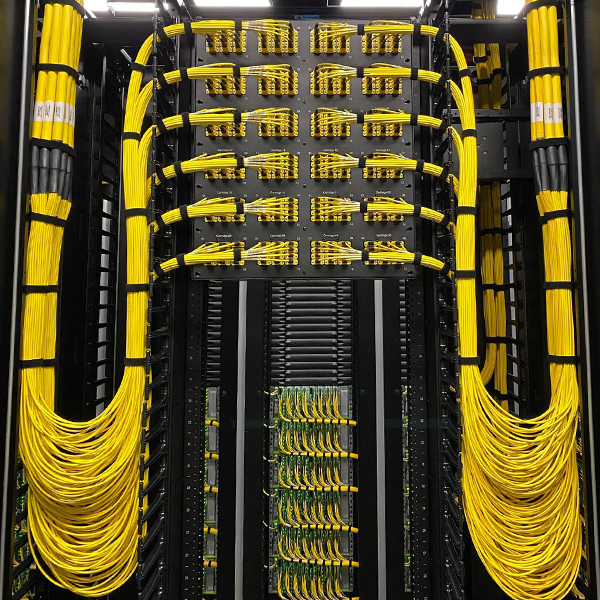 High-density data center interior with server racks and network cabling supporting mission-critical commercial infrastructure.