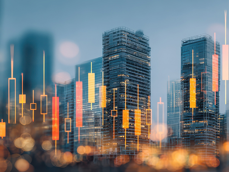 Commercial real estate skyline with illuminated high-rise buildings and financial candlestick chart overlay representing market trends.