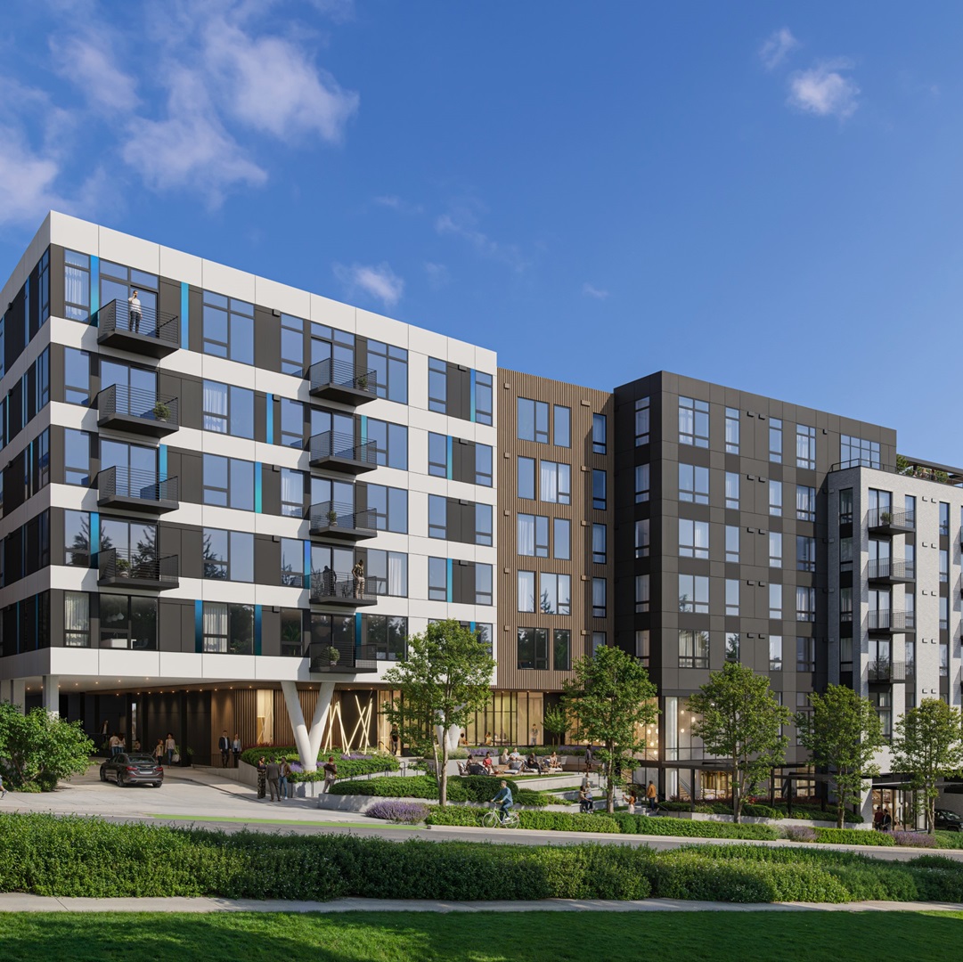 Exterior view of a modern multifamily apartment building with balconies, large windows, and landscaped common areas.