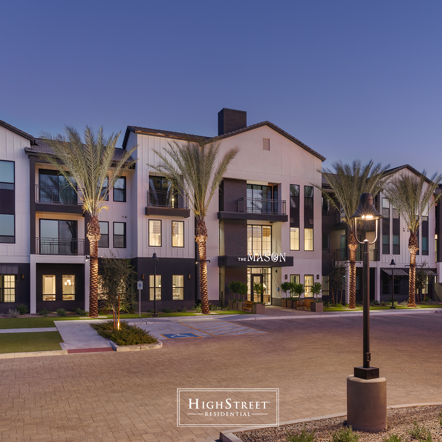Exterior of The Mason multifamily apartment community with modern residential buildings, balconies, palm trees and landscaped grounds.
