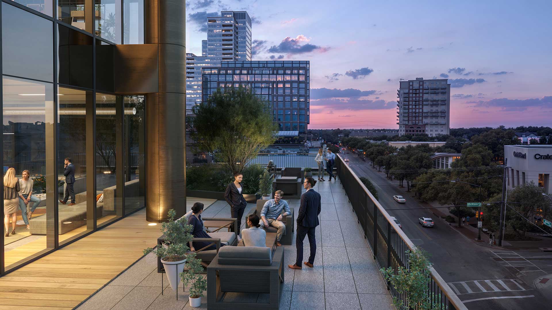 Rooftop terrace at dusk overlooking McKinney Avenue, featuring modern seating, city skyline views, and professionals socializing at a luxury mixed‑use building.