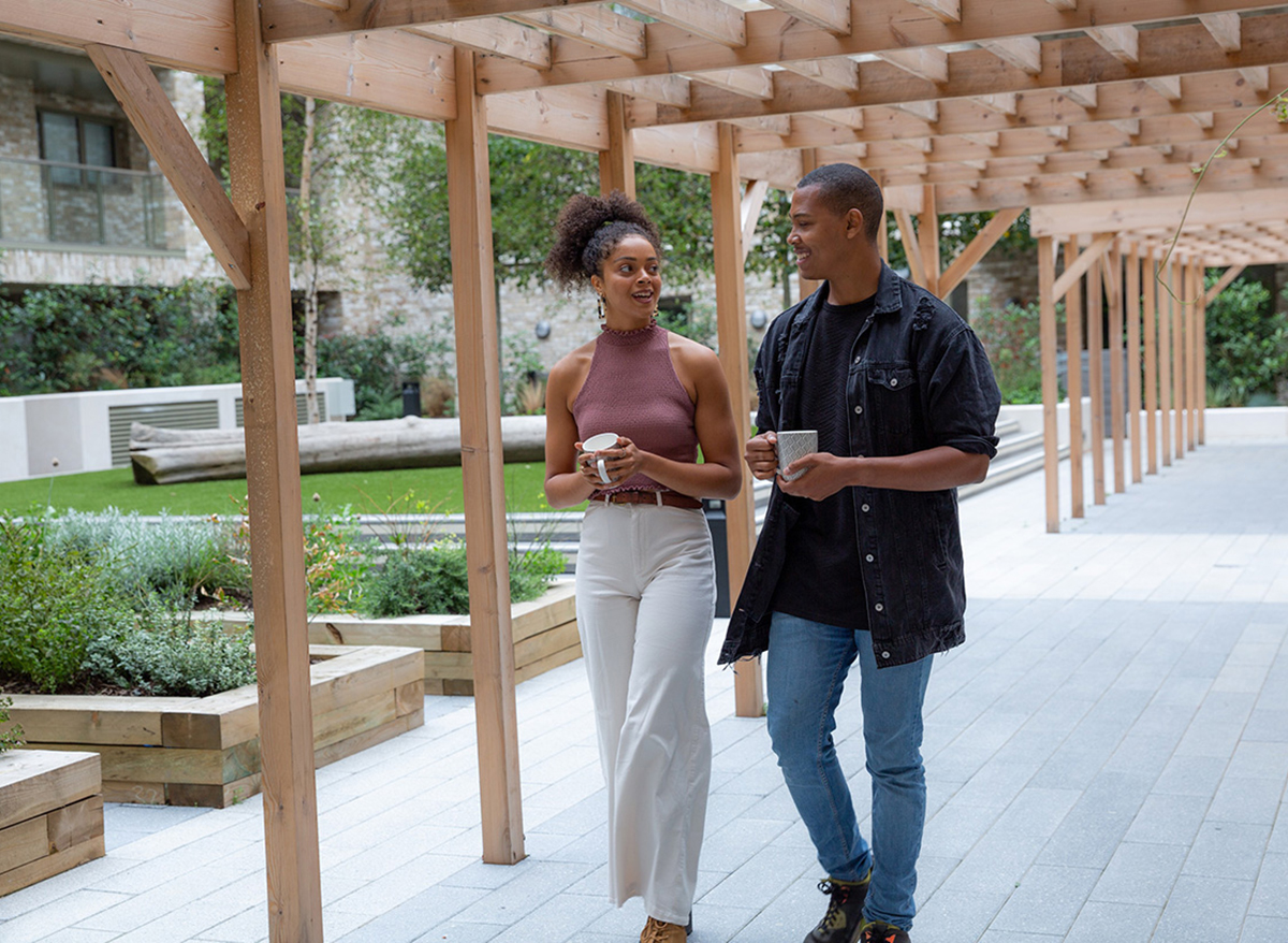 A couple walking through an outdoor area