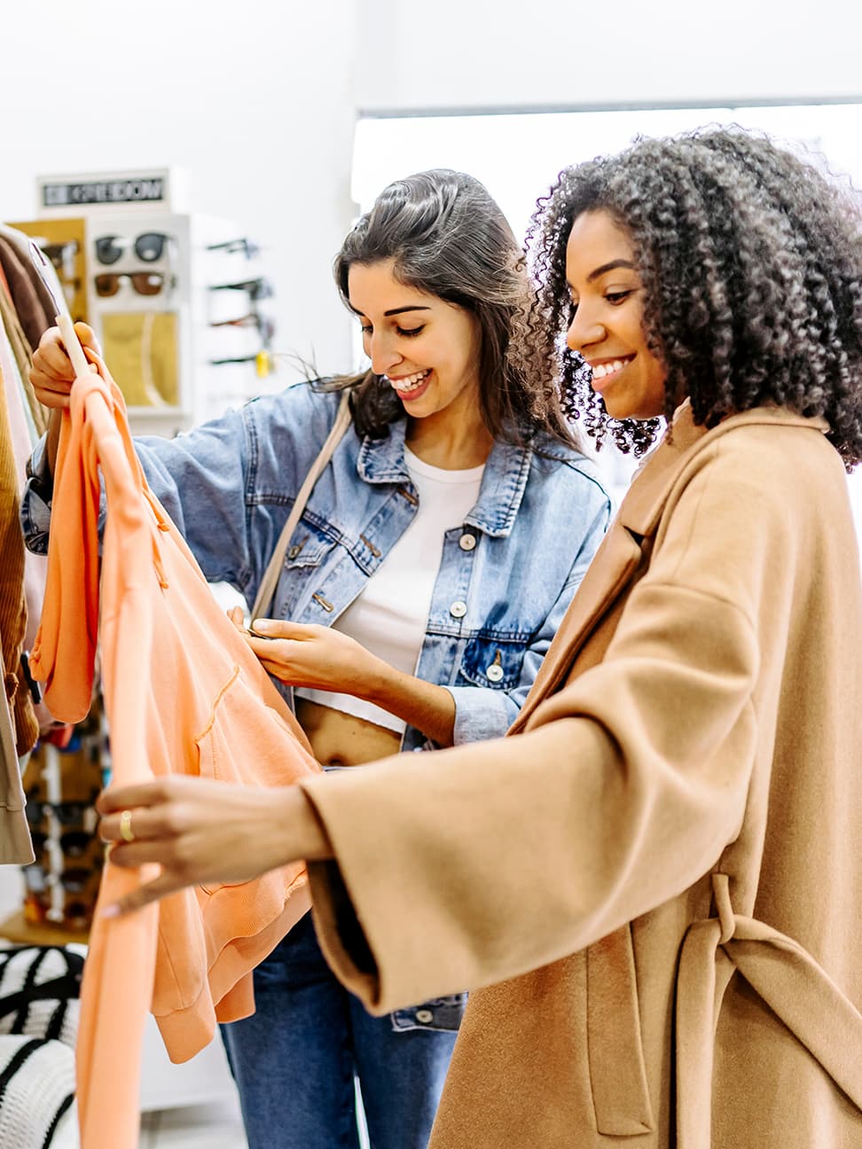 Two women shopping and looking at clothes