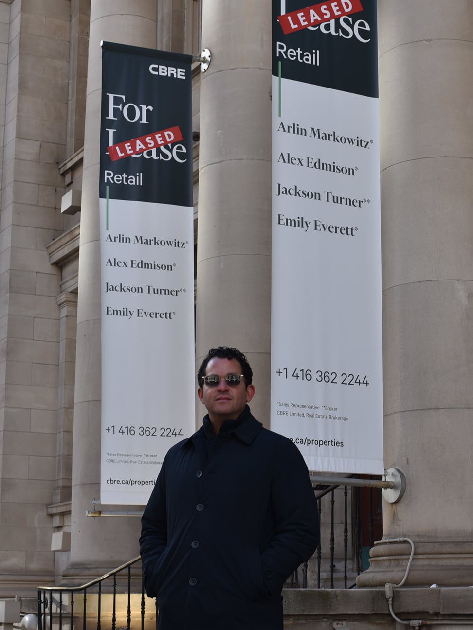Arlin Markowitz in front of CBRE For Lease signage