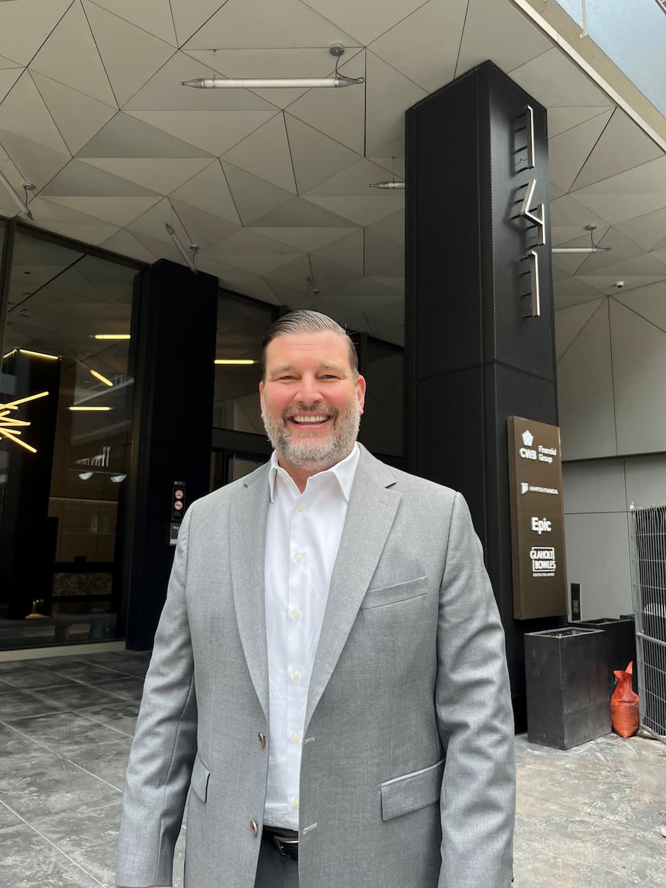 Brendan Sullivan standing in front of a class B office building