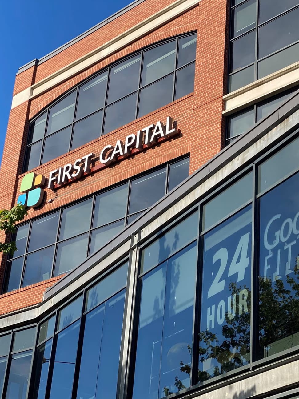 Exterior shot of the red brick First Capital building against a clear blue sky.