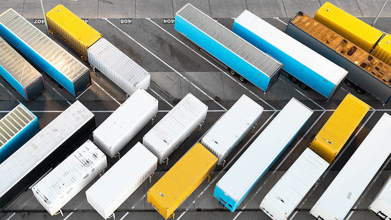 Aerial view of trucks in a distribution center, a large logistics center and industrial outdoor storage