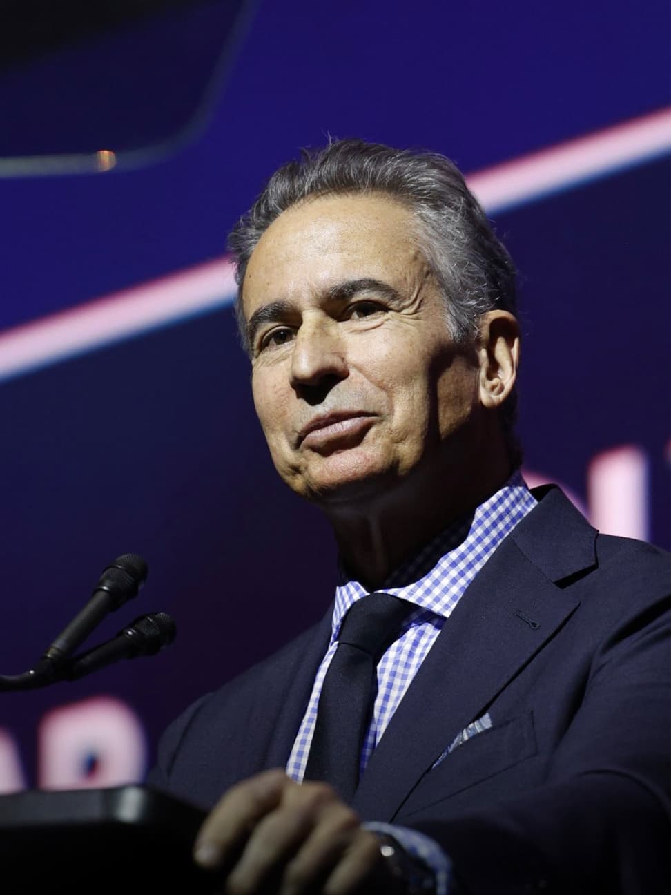 Paul Morassutti speaking at podium at the 2025 Real Estate Forum