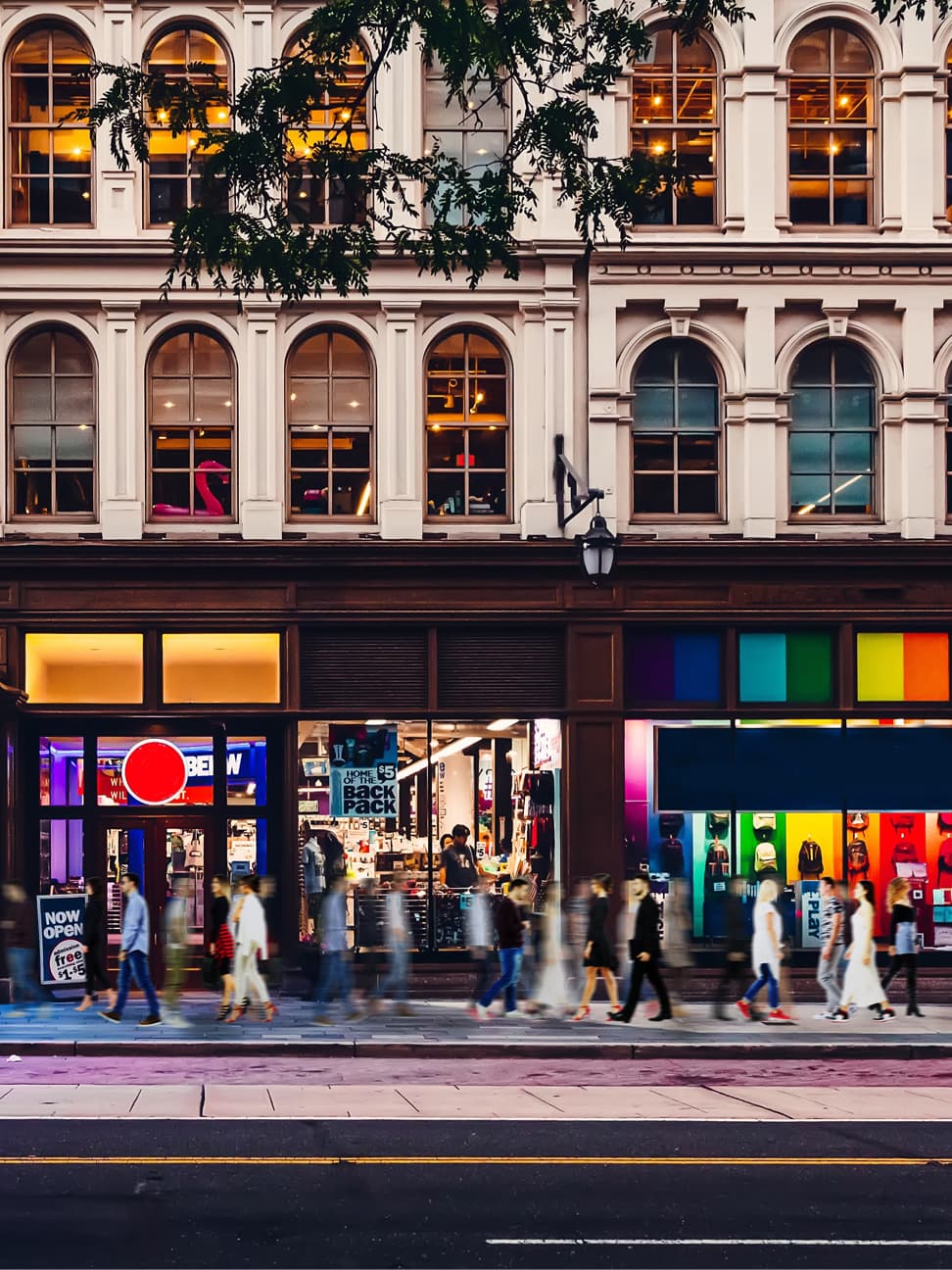 Shoppers on a street in front of store fronts