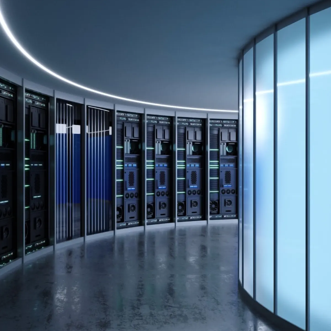 A futuristic, curved server room with rows of black server racks illuminated by subtle green and blue lights, reflecting on the polished floor.