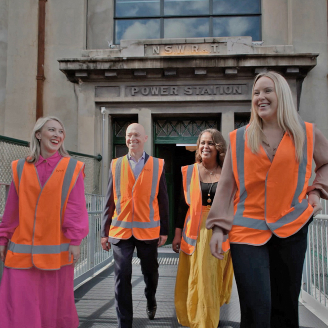 Ash and Fatima inspect a development site with their colleagues. 