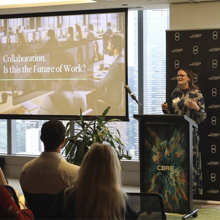 Felicity Marshall presents at a CBRE event, standing at a podium in front of a screen displaying "Collaboration. Is this the Future of Work?", with attendees in the foreground.