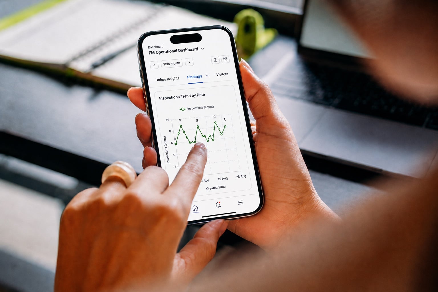 Person using the Pulse Helix app on a smartphone to monitor facility management performance and inspection trends through a mobile dashboard.