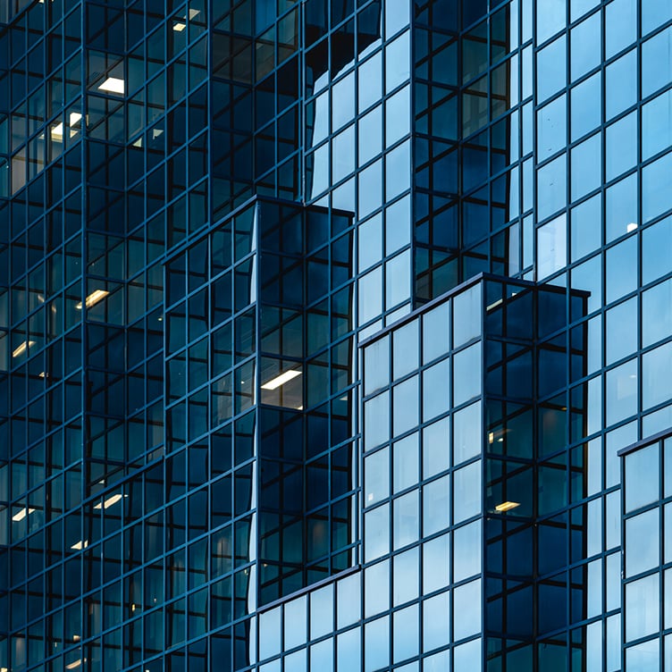 Abstract close-up of a modern glass building's façade.