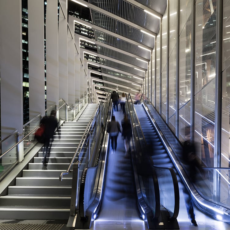 Modern escalator and stairs in a contemporary building, symbolising structured pathways and strategic navigation in real estate portfolio transactions and redevelopment projects. 