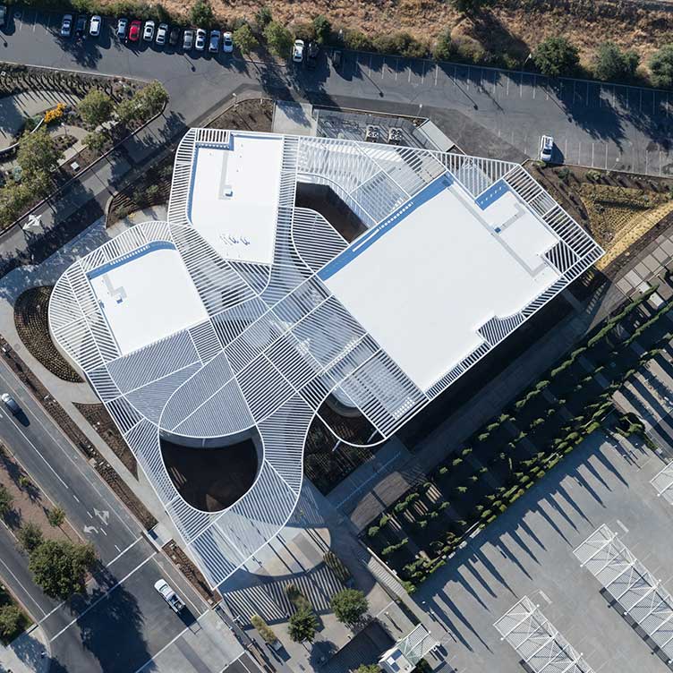 Aerial view of an innovatively designed building in an urban environment, symbolising smart and future-oriented real estate investments.