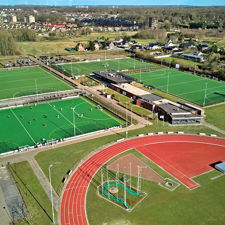 Aerial photograph of a multifunctional sports and amenities complex surrounded by buildings and open space, illustrative of spatial planning and area development.