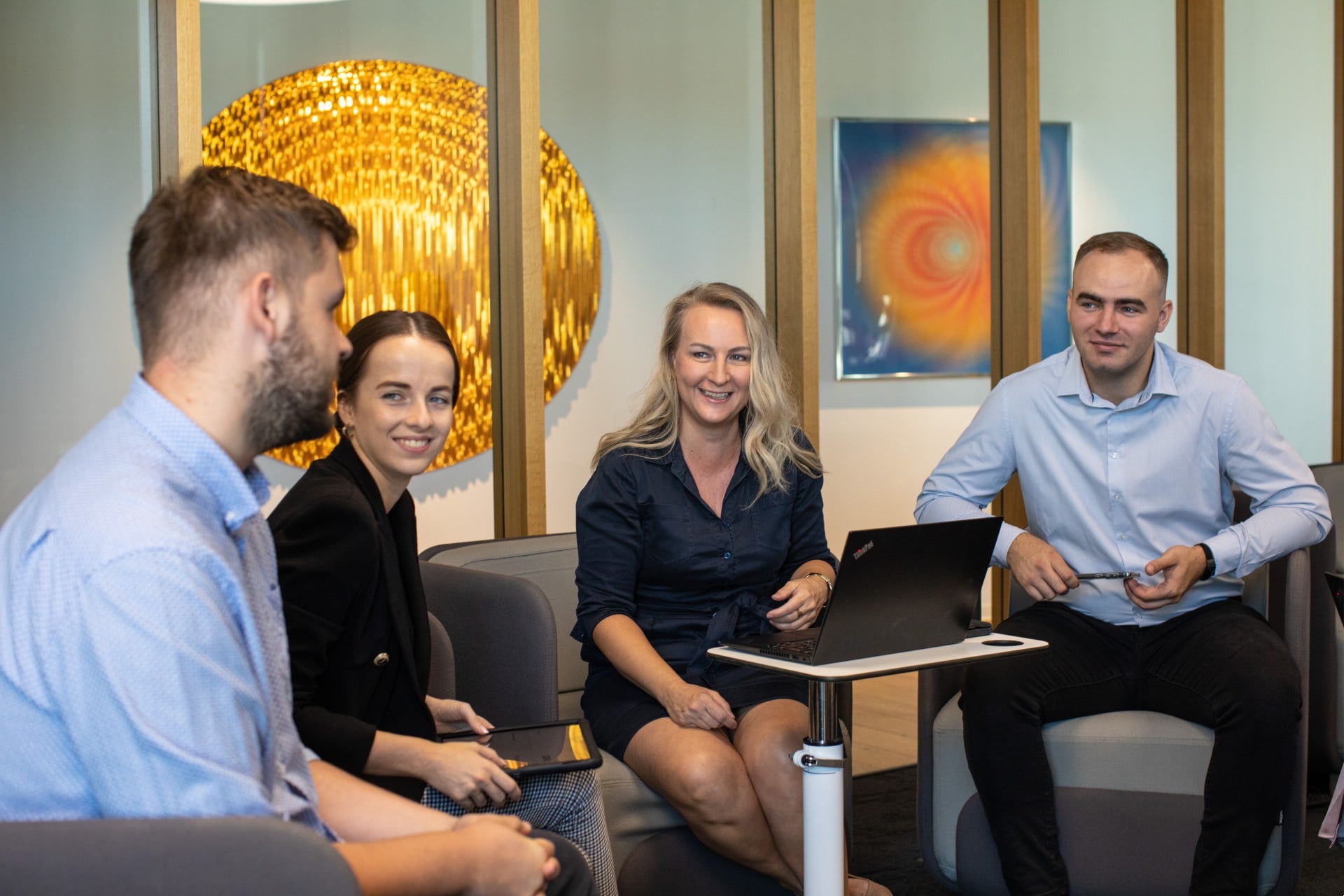group of colleagues having a discussion at a laptop