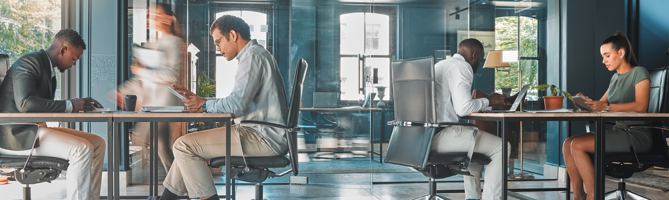 Coworking space, office and sharing desk in corporate workplace. Diversity, efficiency and modern working environment for inclusive company. Start up and motion blur of fast and busy employees