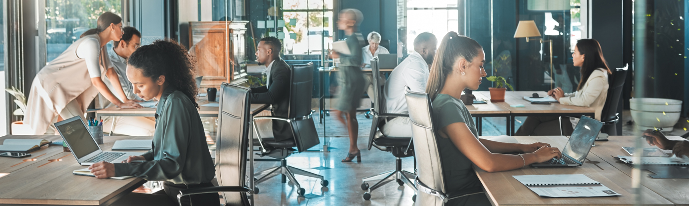 Corporate business people working in busy marketing office space, planning strategy in books and reading email on laptop at work. Businessman, businesswoman and workers at startup advertising company