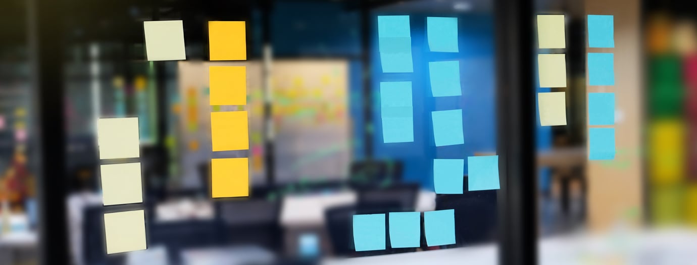 Colorful post it on glass wall at meeting room with marker and sticky notes for people share ideas