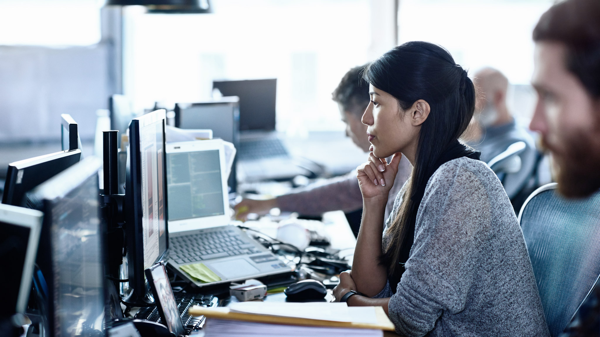 A group of people looking at computer screens
