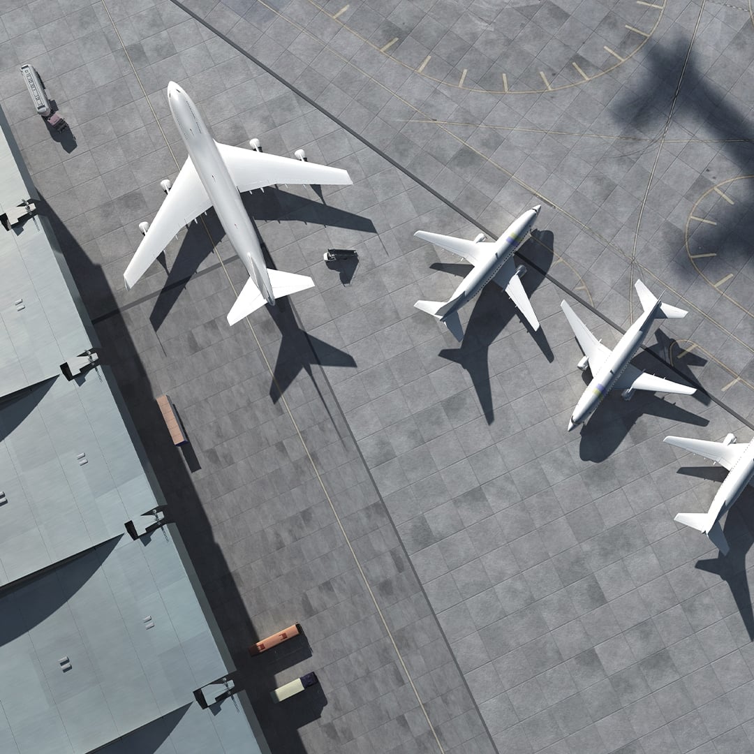 birdseye view of commercial airplanes at airport terminal