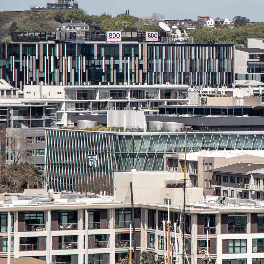 Aerial view of Auckland's central business district (CBD), showcasing modern and historic architecture.  CBRE Q4 2024 Market Report