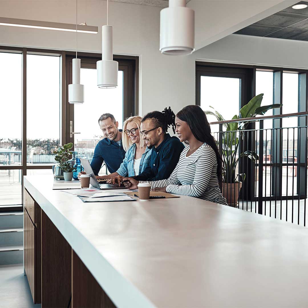 Four people working together at a table.