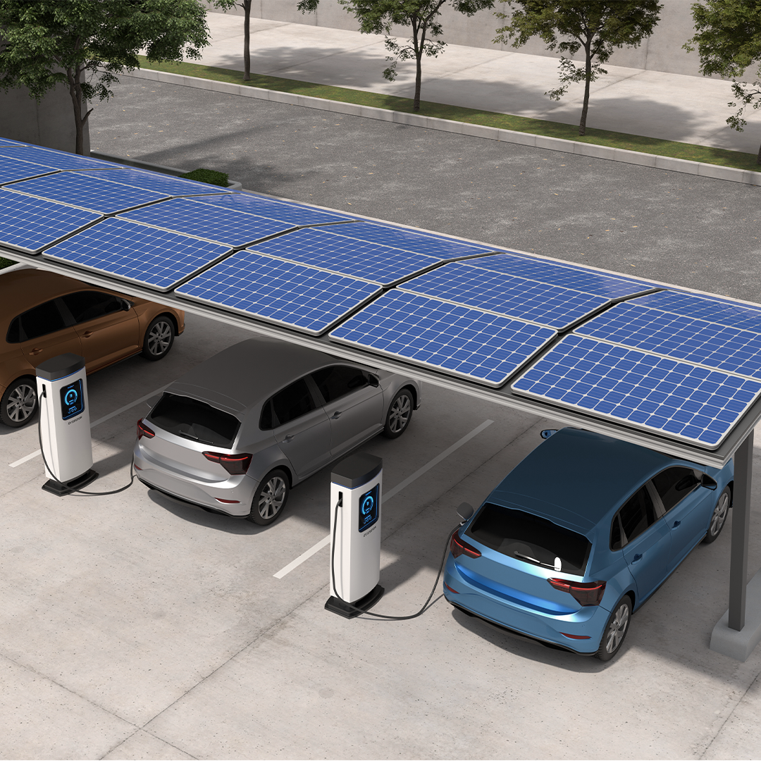 Image of three electric vehicles charging under a solar panel canopy in a parking lot.