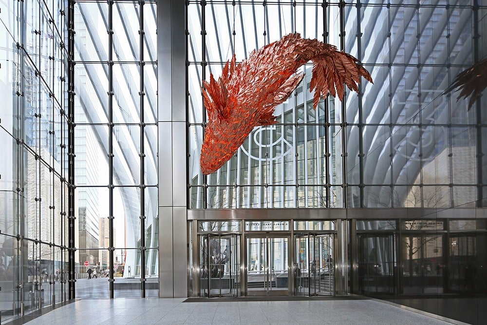 Frank Gehry's copper Fish on Fire sculpture suspended in the glass lobby of 3 World Trade Center in New York City 2024.