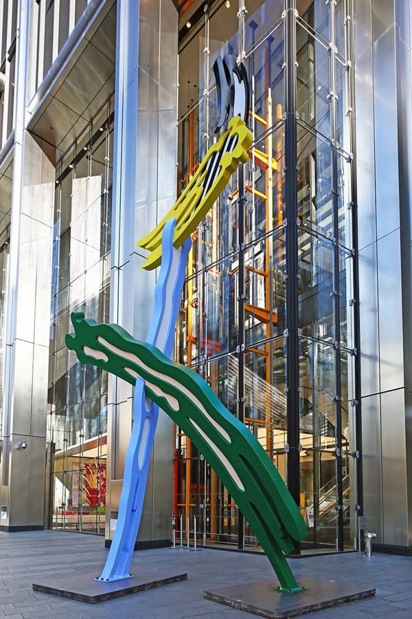 Roy Lichtenstein's Brushstrokes large-scale colorful pop art sculpture in green blue and yellow installed at the plaza entrance of 3 World Trade Center.