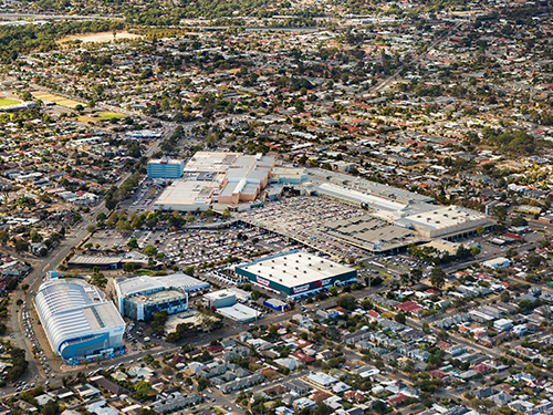 Aerial view of a major retail and commercial precinct integrated within a well-established suburban residential catchment.