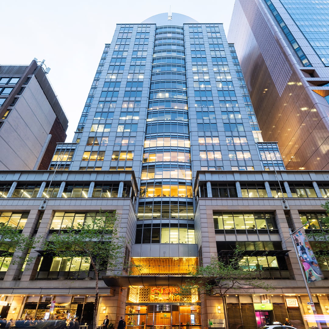 Premium office tower with a contemporary glazed façade and activated ground-floor retail frontage in a prominent central business district location.