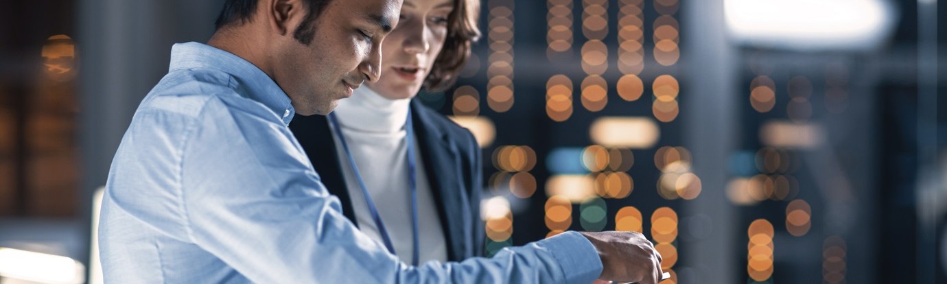 two colleagues looking over a tablet computer