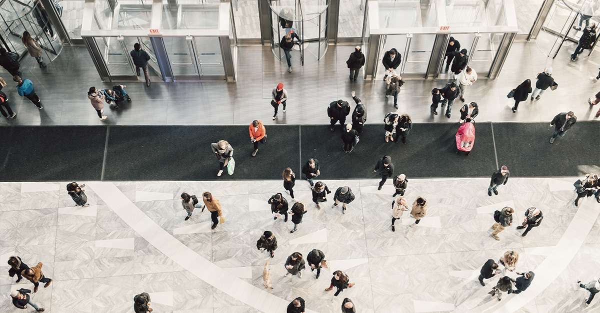 Crowd of people in a large lobby.
