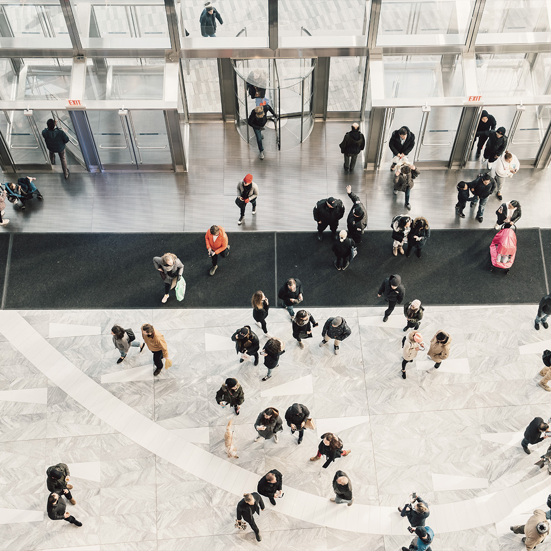 Crowd of people in a large lobby.